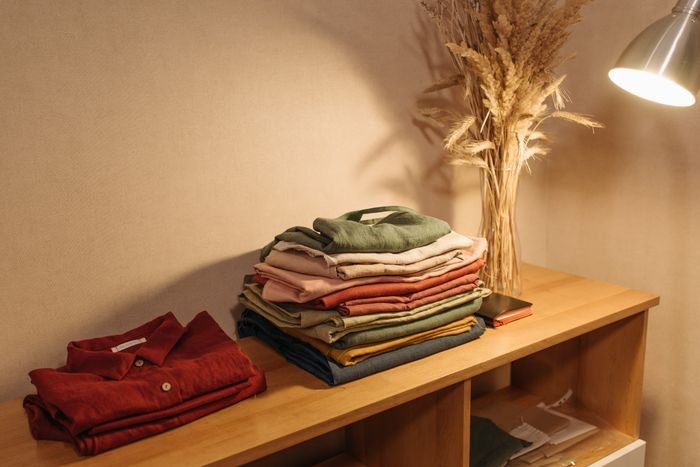Neatly folded clothes on a shelf