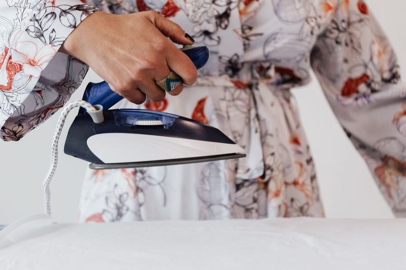 Steam iron pressing fabric