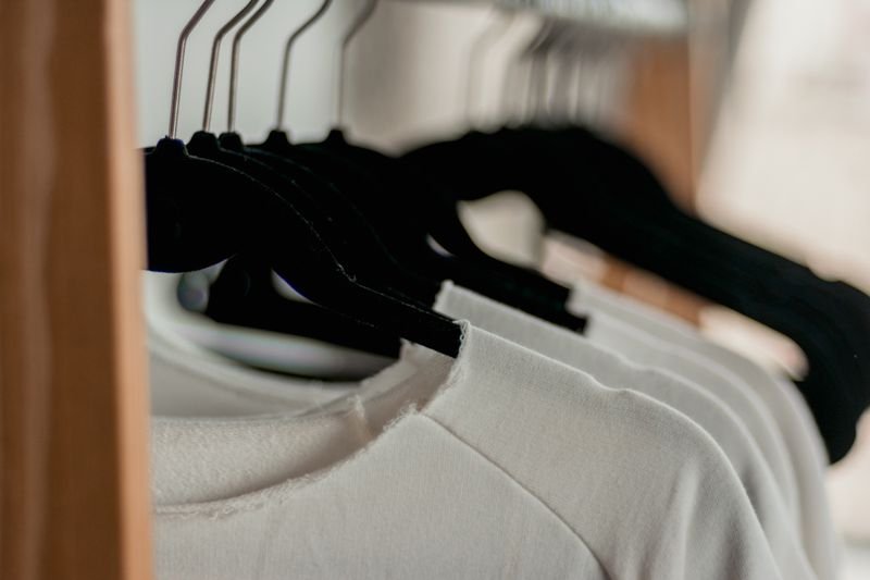 White shirts hanging on clothes hangers